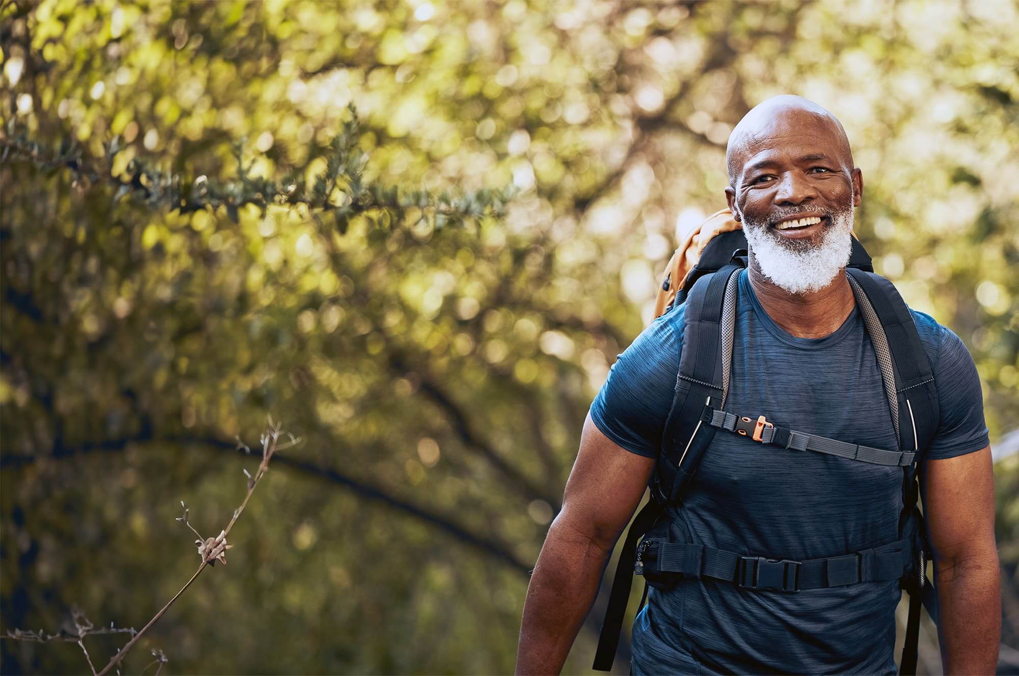 Smiling older man enjoying a hike outdoors