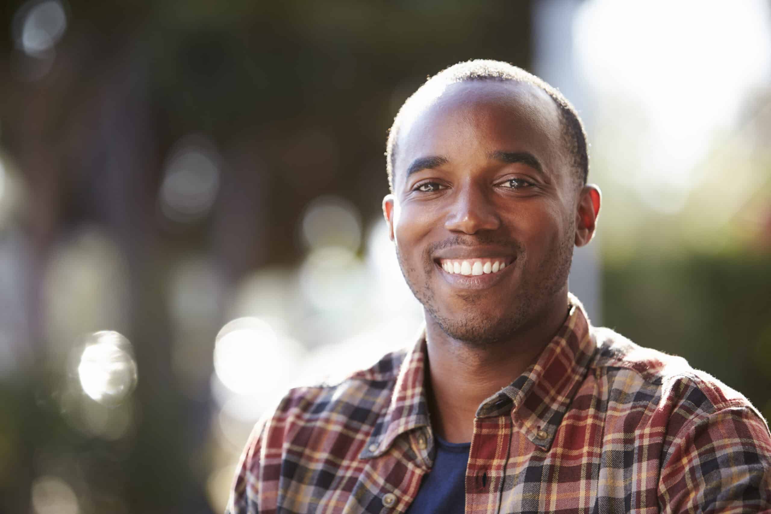 Man smiling outdoors after dry eye treatment