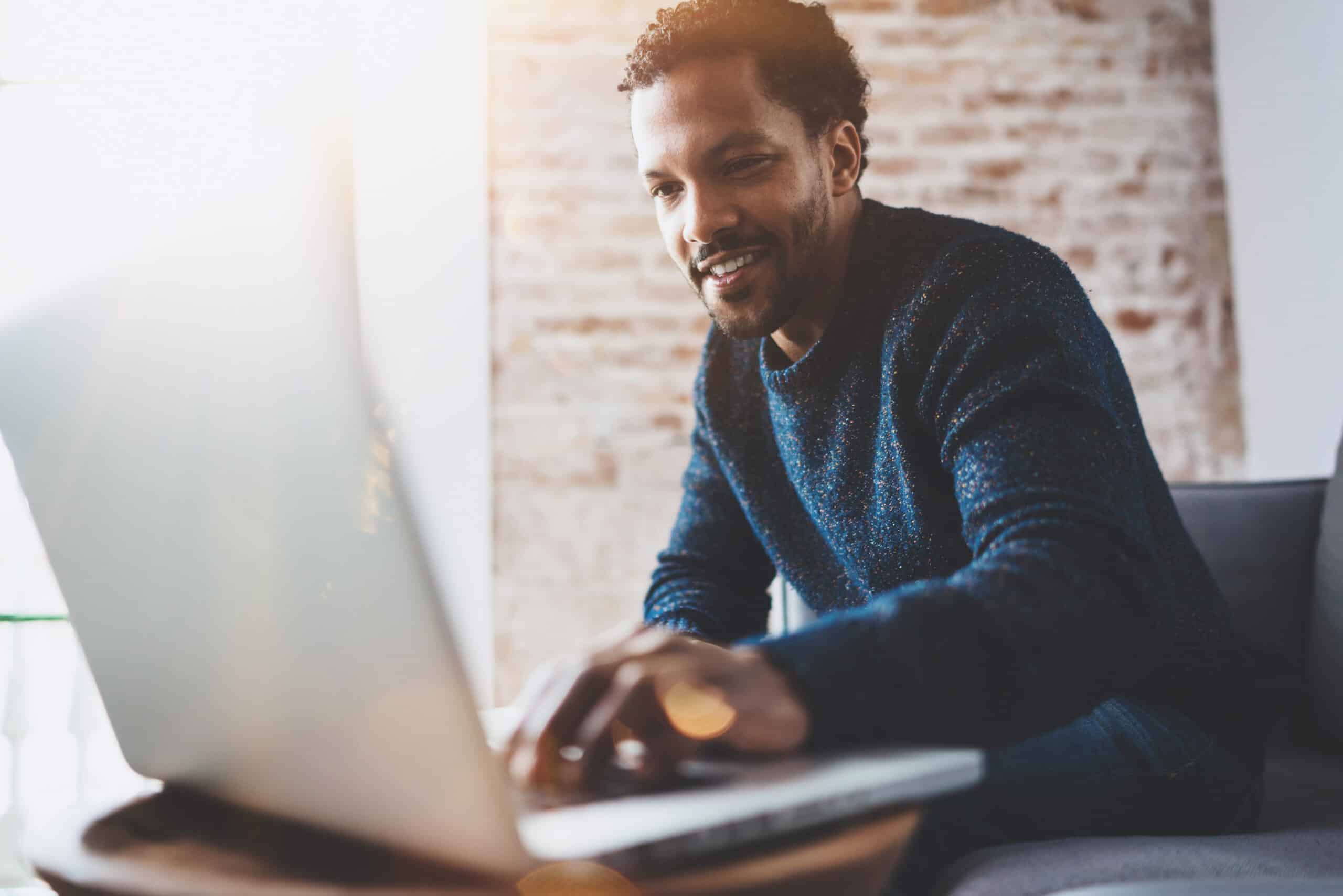 Man reviewing patient resources on a laptop